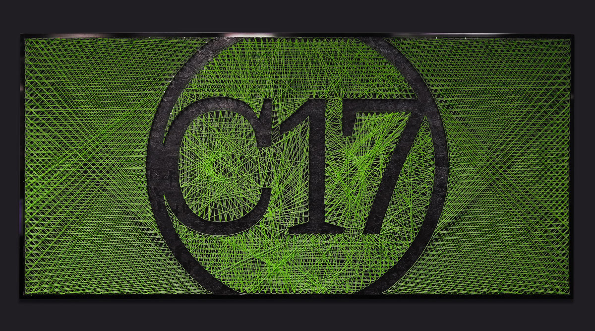 C17media logo with green geometric lines on a dark background, representing creativity and innovation in print and visual communication services.