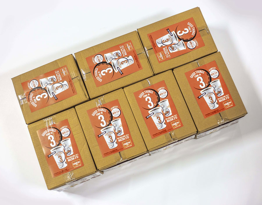 Boxes of Country Style coffee cups featuring "Good Things Come in 3's" promotion, showcasing branding and contest details.
