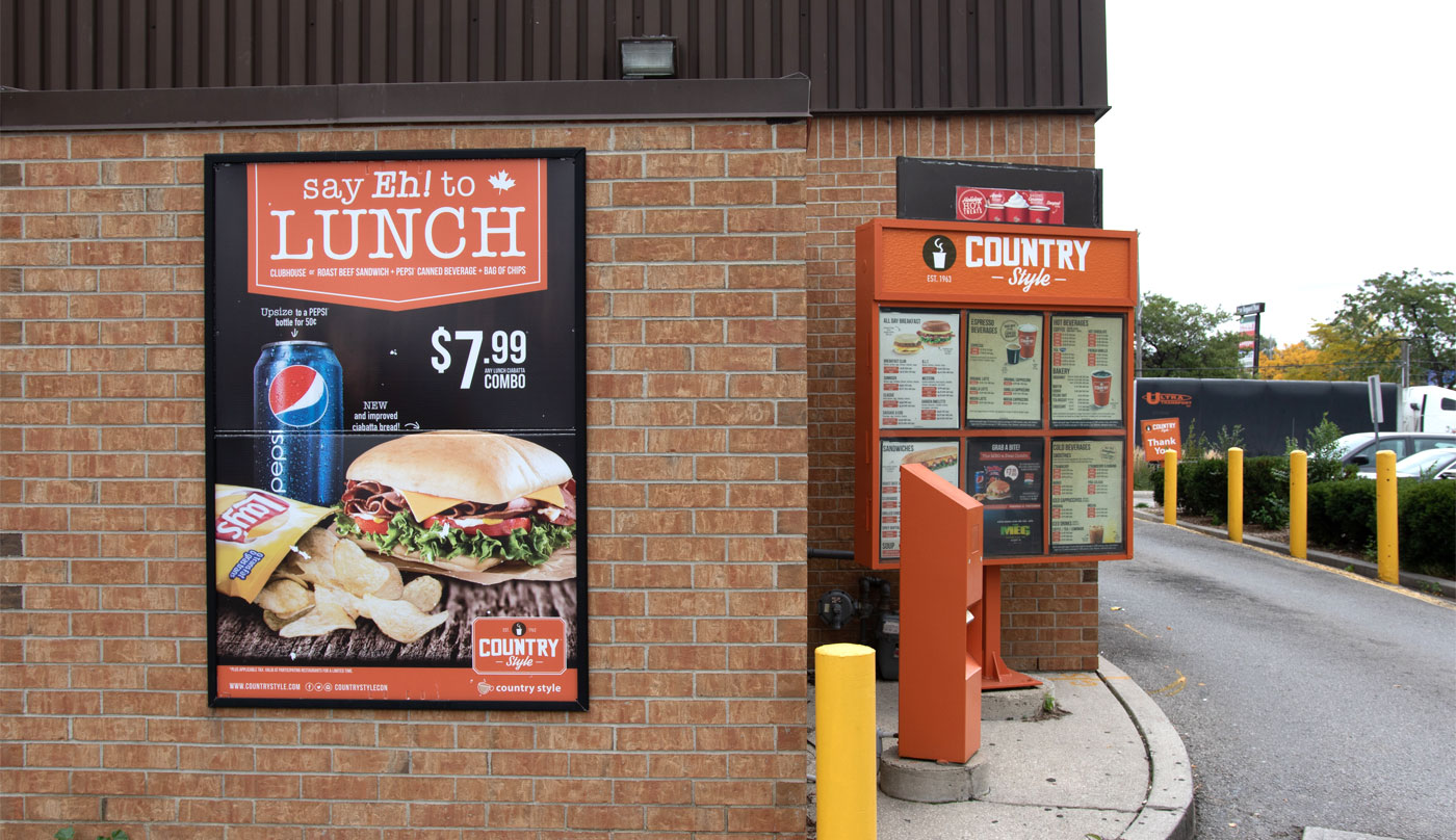 Country Style drive-thru menu featuring lunch promotion, including sandwich, Pepsi drink, and chips, with pricing details and branding elements.