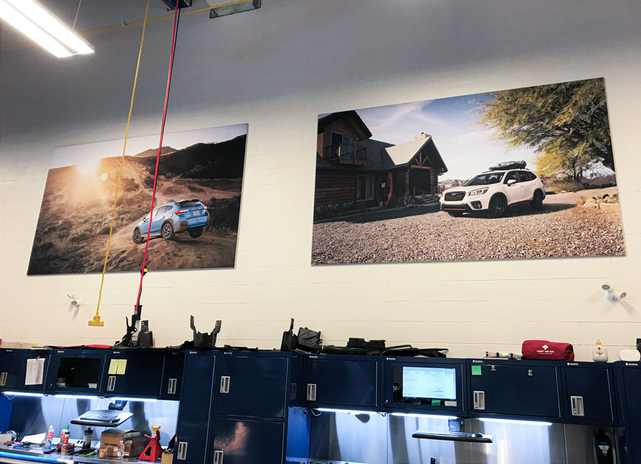 Fabric prints of Subaru vehicles displayed on walls in the Pfaff Subaru Guelph dealership, showcasing lifestyle imagery that enhances the brand experience and customer engagement.