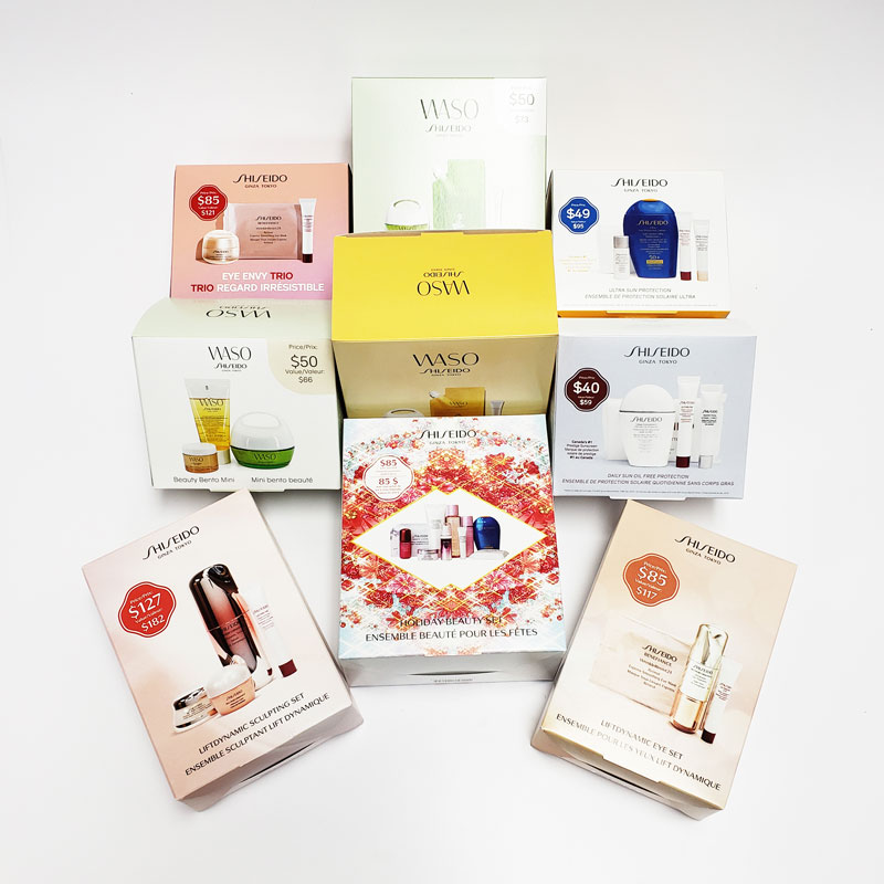 Shiseido product packaging boxes featuring WASO and other skincare sets, displaying vibrant colors and price tags, emphasizing premium brand image and design quality.