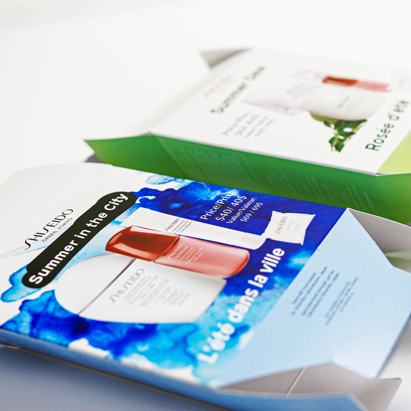 Shiseido Summer in the City packaging design featuring vibrant blue and green colors, showcasing premium skincare products with pricing details and brand logo.