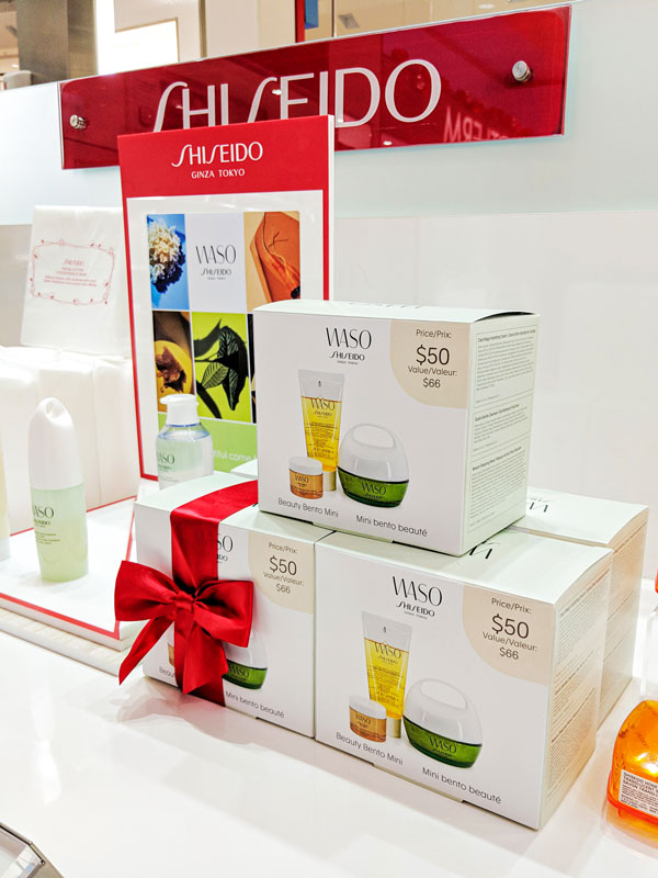 Shiseido display featuring WASO product packaging, including Beauty Bento Mini sets with price tags, promotional materials, and a minimalist aesthetic emphasizing premium quality.