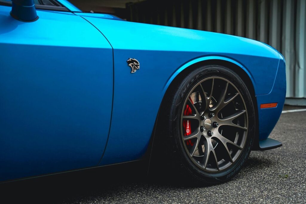 A vibrant blue car with alloy wheels.
